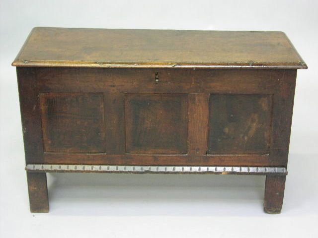 A 17th Century oak coffer with hinged rectangular top,