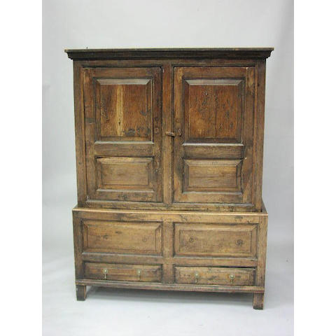 A George III oak enclosed cupboard,