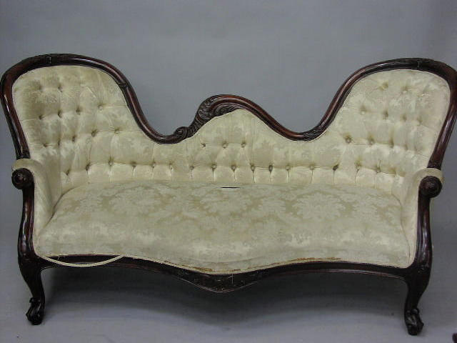 A Victorian carved walnut double ended settee,