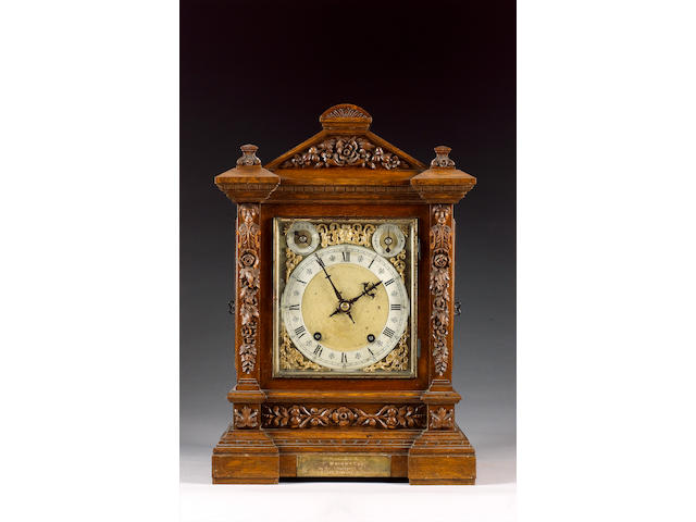 A late 19th Century German carved oak ting tang quarter chiming mantel clock, Winterhalder and Hoffmeier, the architectural case with carved pediment over an inverted breakfront base, the brass and silvered Roman dial with subsidiaries for regulation and chime/silent over a matted centre, the movement with anchor escapement, striking on two coiled steel gongs 46cm high.