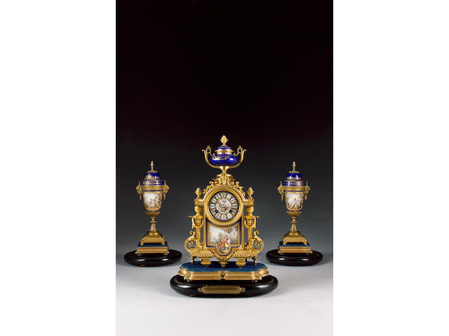 A late 19th century French gilt metal 'jewelled' porcelain mounted clock garniture The movement stamped Japy Freres and B.R.8388 9