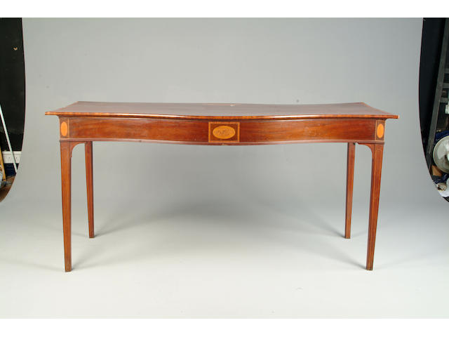A George III mahogany, satinwood banded and inlaid serpentine serving table