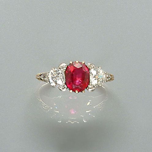 A ruby and diamond three-stone ring