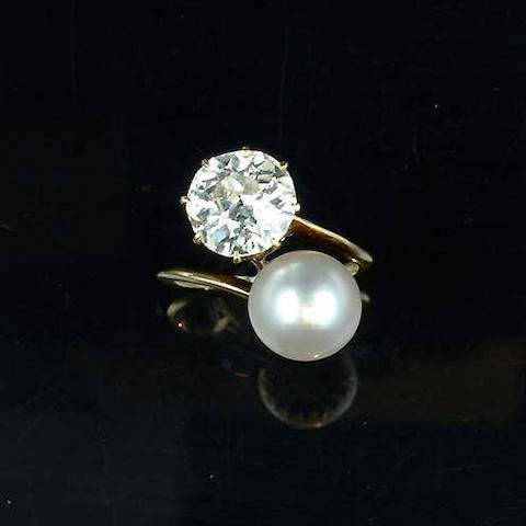 A pearl and diamond two-stone crossover ring