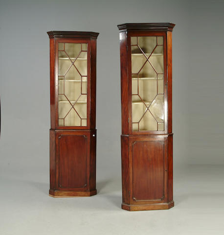 A pair of 19th century mahogany floor standing corner cupboards