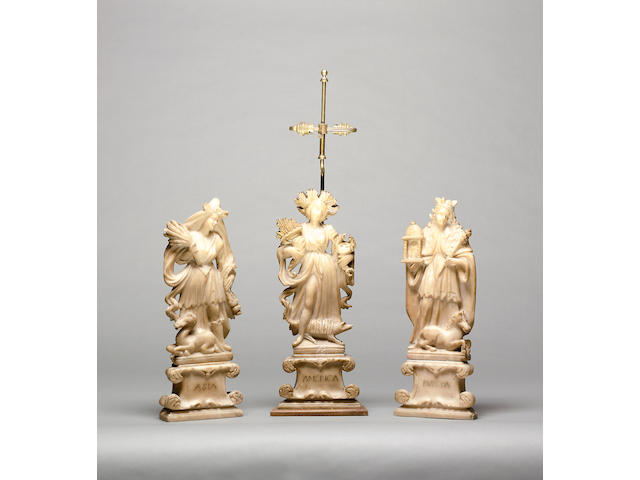 A part set of three early 18th century Italian carved and parcel gilt alabaster allegorical figures depicting the continents