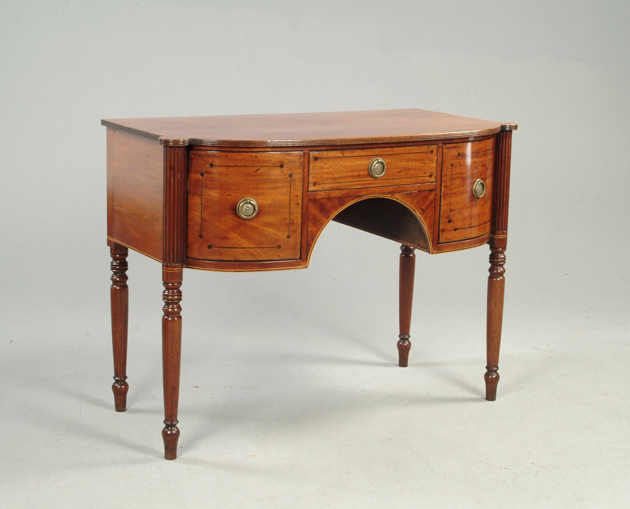 A small Regency mahogany bowfront dressing table