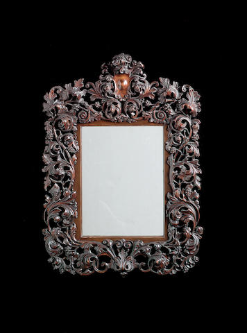 An early 20th century carved walnut mirror