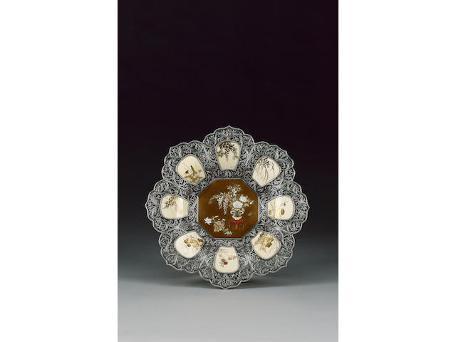 An elegant reticulated white metal dish,