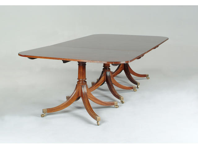 A George III style mahogany triple pillar dining table