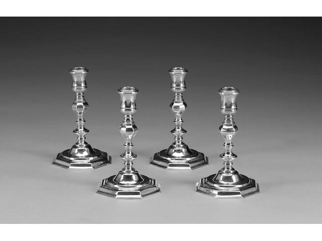 A set of four cast silver candlesticks, in the 18th century style, London 1963,