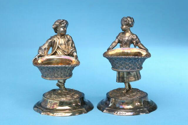 A pair of Victorian figural salts, by Alfred Benson and Henry Hugh Webb, London 1893, inscribed Hunt and Roskell, late Storr and Mortimer and numbered 939,
