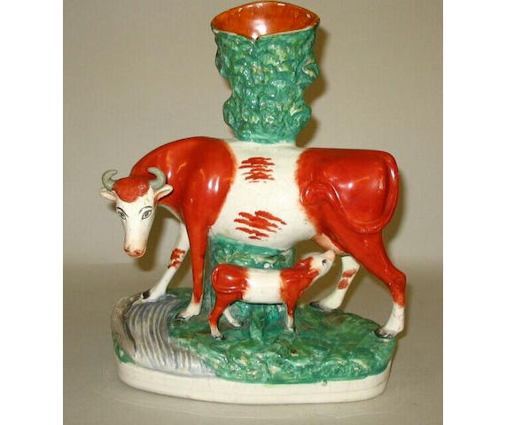 A Staffordshire model of a cow and calf,