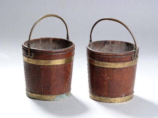 A pair of mahogany peat buckets, with two brass bands and loop handles, 30 x 30cm (replacement base to one basket).