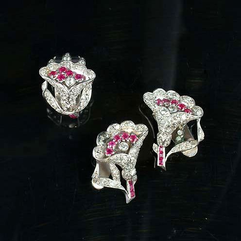 A ruby and diamond ring and earclip suite