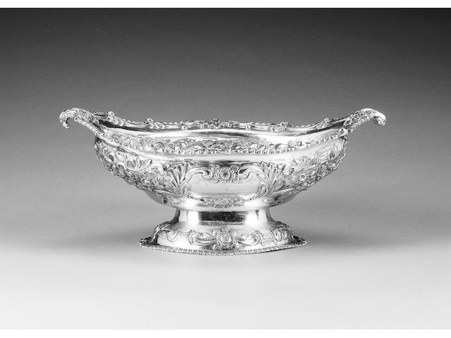A late Victorian silver shaped oval fruit bowl, London 1900, and an Edwardian silver oval basket, by Goldsmiths & Silversmiths Co., London 1902, (2)
