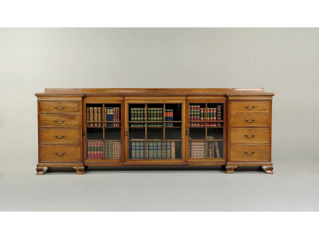 A large George III style walnut inverted breakfront bookcase