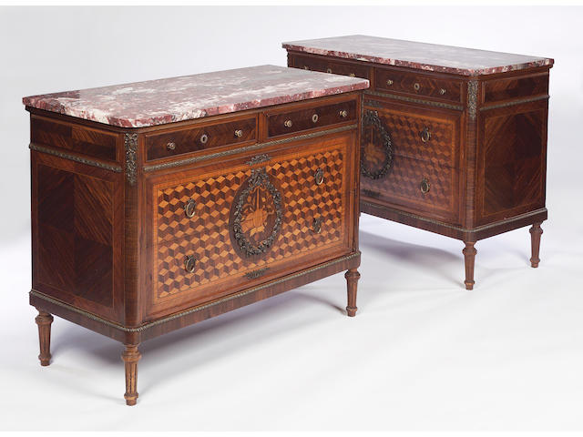 A pair of parquetry Louis XVI style rouge royal marble topped commodes