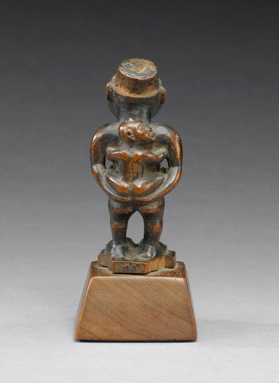 A Kongo maternity fetish figure two of the corners chipped, 10.2cm