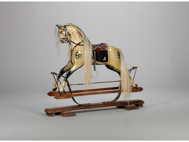A fine and rare F H Ayres Spring Rocking Horse with King George V Royal Cypher saddlery, circa 1910 Exhibited at the Guards Museum, London.  It is believed this rocking horse was made for one of the children of King George V, who came to the throne in 1910.
