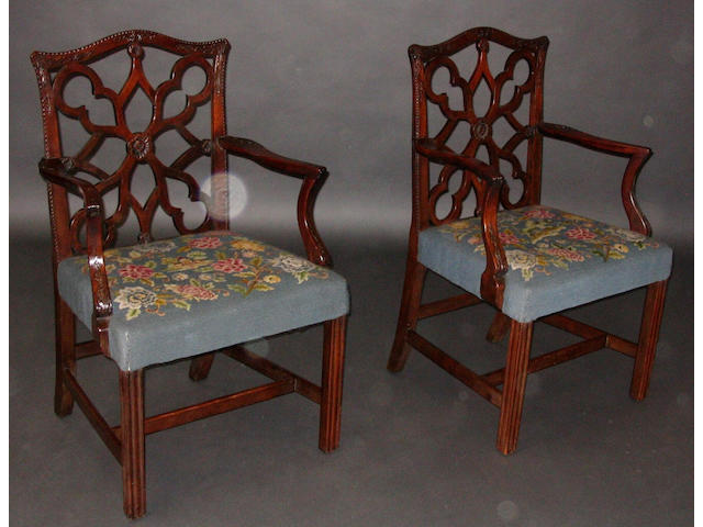 A pair of George III provincial mahogany open arm elbow chairs