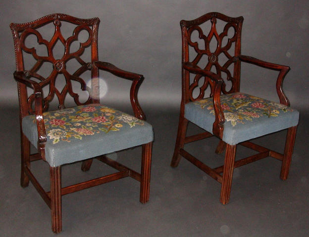 A pair of George III provincial mahogany open arm elbow chairs