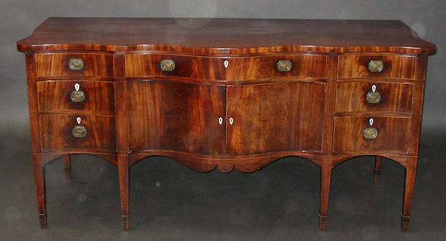 A late 18th Century figured mahogany and boxwood line inlaid serpentine fronted sideboard of good colour