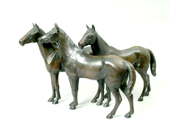 A bronze group of three thoroughbred horses, 30cm high x 44cm wide