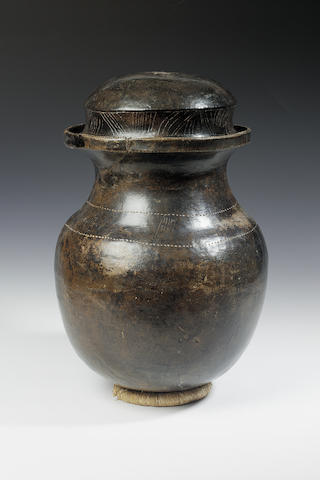 A Large Columbian polished earthenware urn and lid the lid 24.5cm. diam.