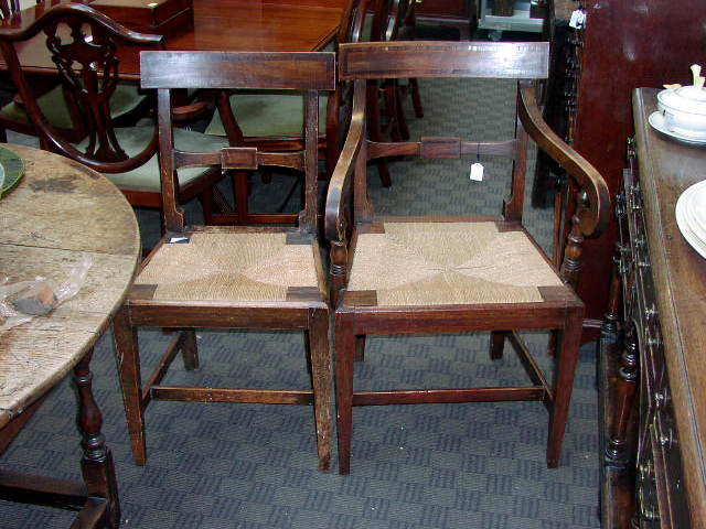 A set of eight early 19th Century country made elm dining chairs,