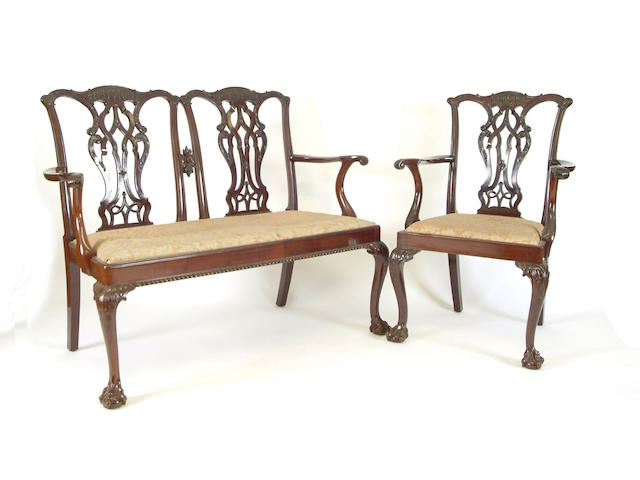 A Chippendale style carved mahogany twin chairback settee and a pair of elbow chairs by Baker of Bath
