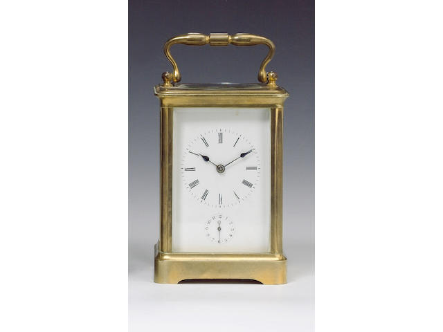 A late 19th Century gilt brass French striking carriage clock with alarm,