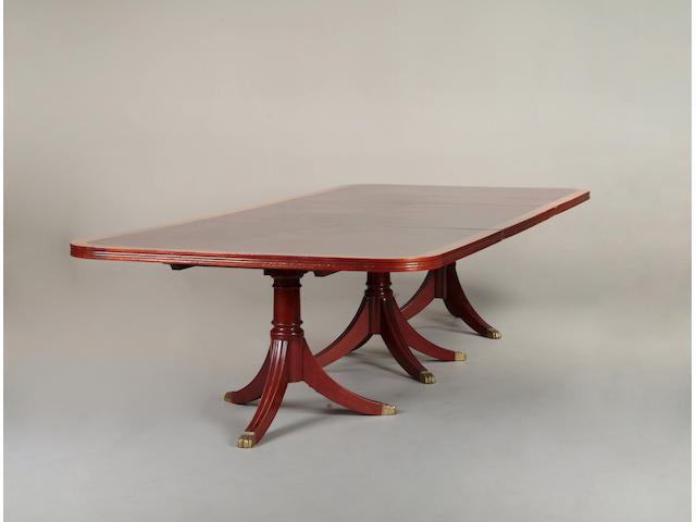 A George III style mahogany and crossbanded triple pillar dining table