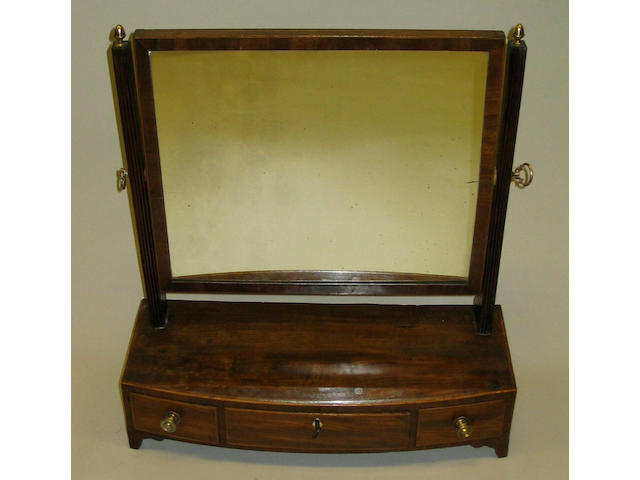 An early 19th Century mahogany and line inlaid toilet mirror,