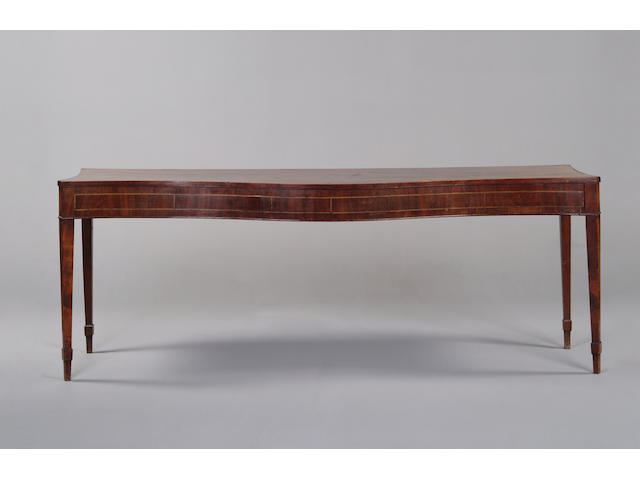 A George III mahogany crossbanded serpentine serving table