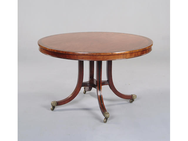 A mahogany and ebony inlaid snaptop circular table