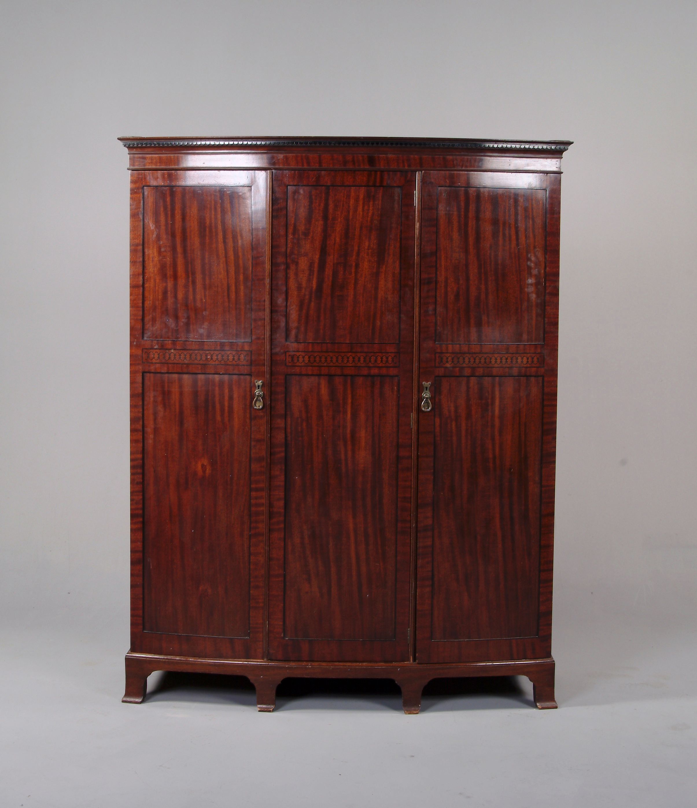 A mahogany two section bowfront wardrobe