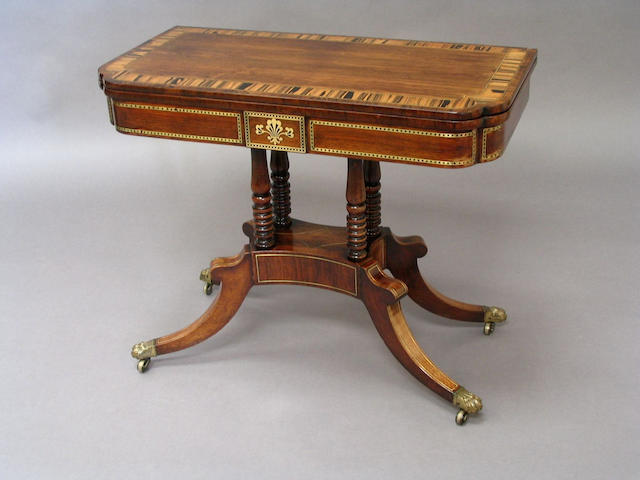A Regency rosewood and brass inlaid card table