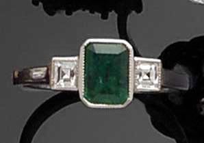 An emerald and diamond ring