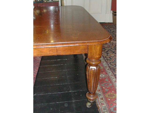 A Victorian oak wind-out dining table with four additional leaves,