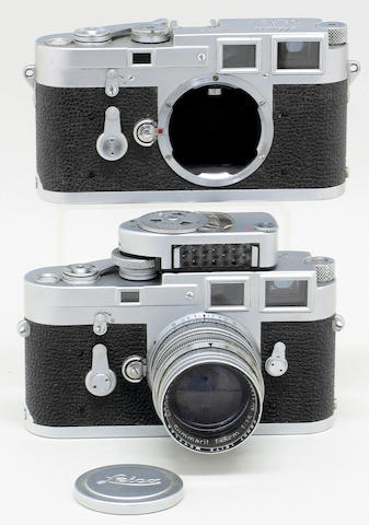 Leica M3 cameras Two chrome bodies, the first No. 986556 single stroke fitted with a bayonet mount Summitar f1.5/5cm lens No. 1187252 with UV filter and cap and MC meter, with a second body No. 754180, (shutter not operating). (5)