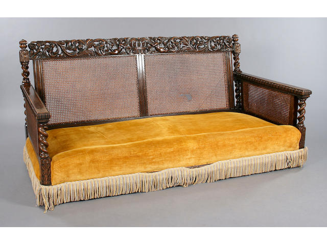 an early C20th oak three piece bergere suite