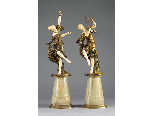 Rene Paul Marquet (French, b. 1875): A pair of gilt bronze chryselephantine figures of dancing classical female musicians
