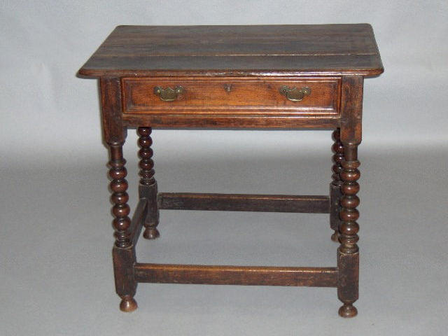 A late 17th century oak side table,