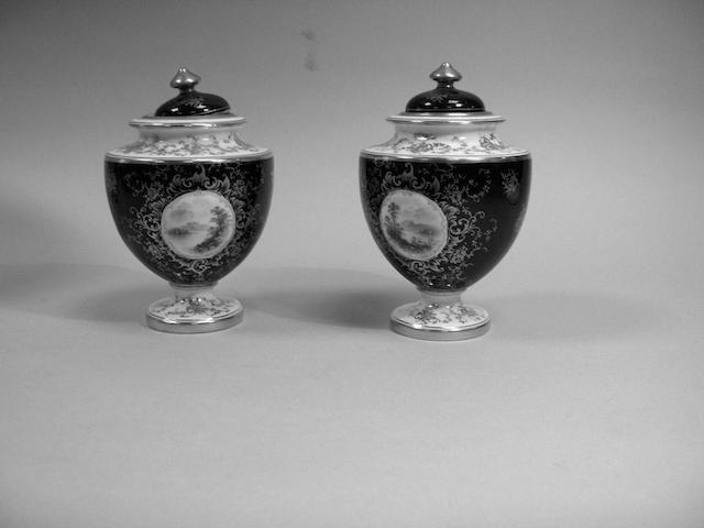 A pair of Coalport porcelain vases and covers,