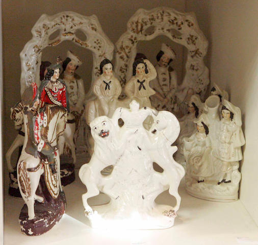 A pair of 19th century Staffordshire pottery figure groups, depicting a couple, together with three further figure groups, a pair of equestrian figures and an Armorial group