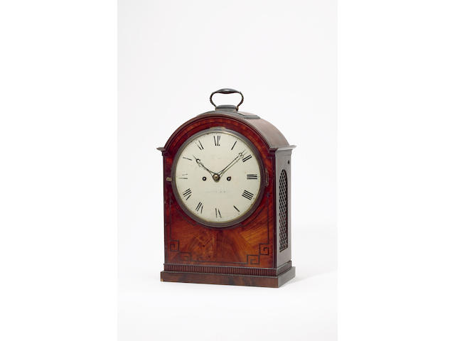 A late Georgian mahogany bracket clock By Dawson, Haddington, with circular enamelled dial, the case with arch top, brass-inlaid lined, side grilles and band of ribbing at the plinth  38cm high.