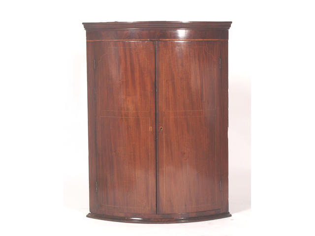 A Regency mahogany wall mounted corner cabinet