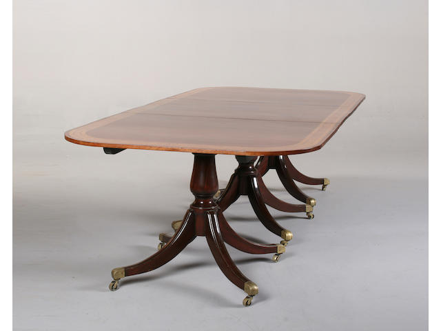 A George III style mahogany triple pedestal dining table