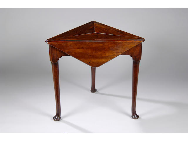 An unusual George II mahogany triangular envelope card table,